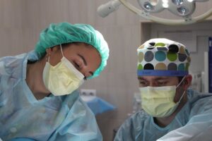two surgeons working on a patient