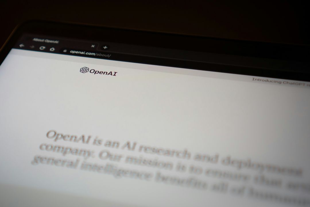 a picture of a screen showing OpenAI, a company creating generative AI technologies